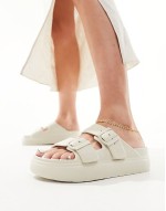 Freestyle flatform double buckle footbed sliders in off-white