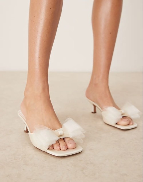 Hyper bow detail mid heeled mules in ivory